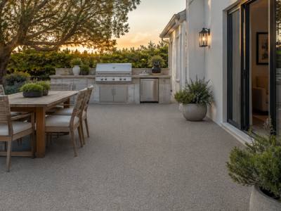 Backyard patio finished in rubber surfacing at dusk